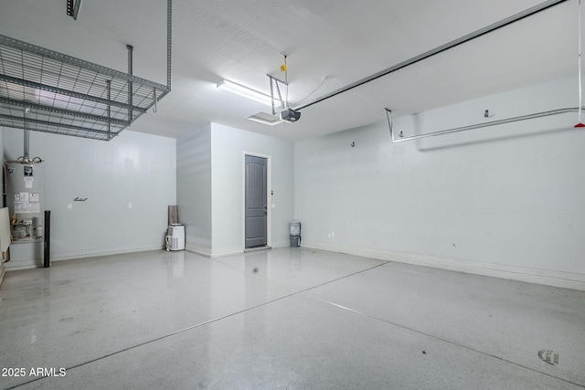 garage featuring water heater, a garage door opener, and baseboards