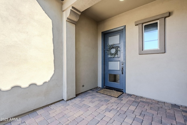 doorway to property with stucco siding