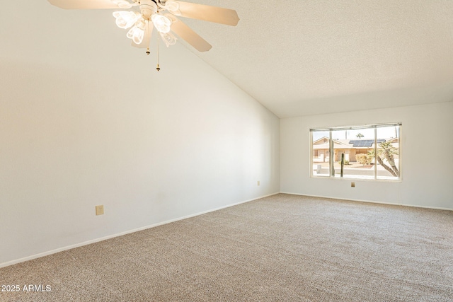 unfurnished room featuring ceiling fan, vaulted ceiling, a textured ceiling, and carpet