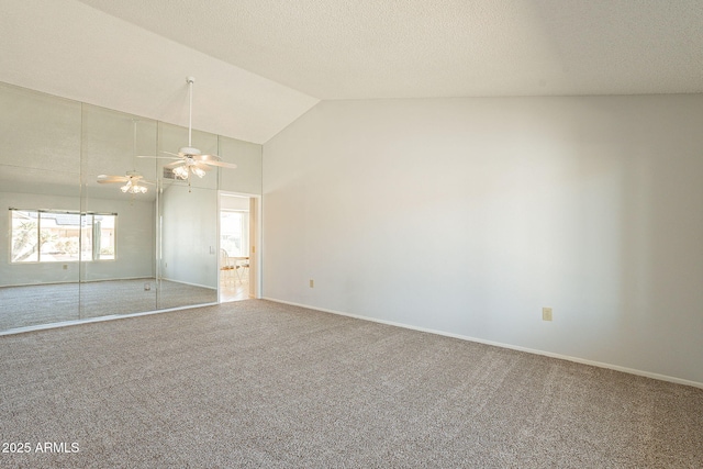 spare room featuring ceiling fan, carpet, high vaulted ceiling, and a textured ceiling