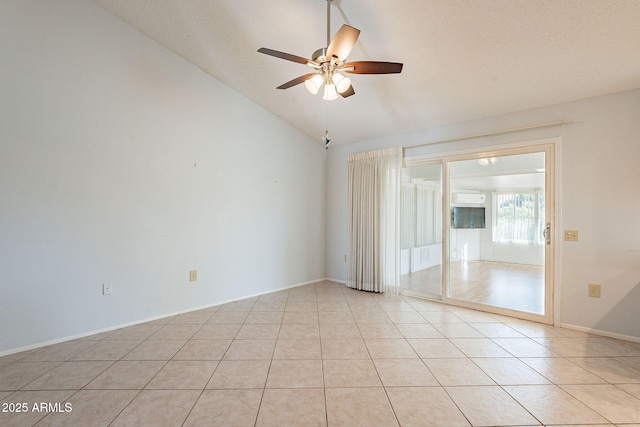 spare room featuring vaulted ceiling, ceiling fan, and light tile patterned flooring