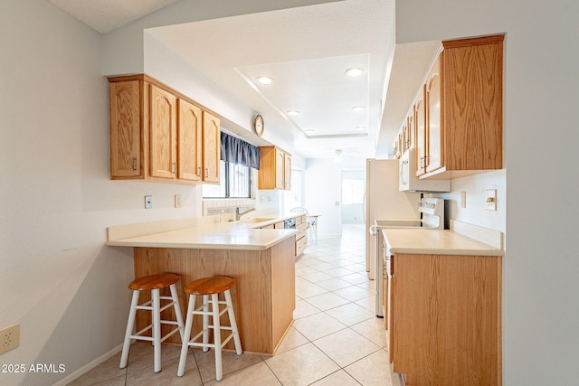 kitchen with light tile patterned flooring, electric range oven, sink, a kitchen bar, and kitchen peninsula