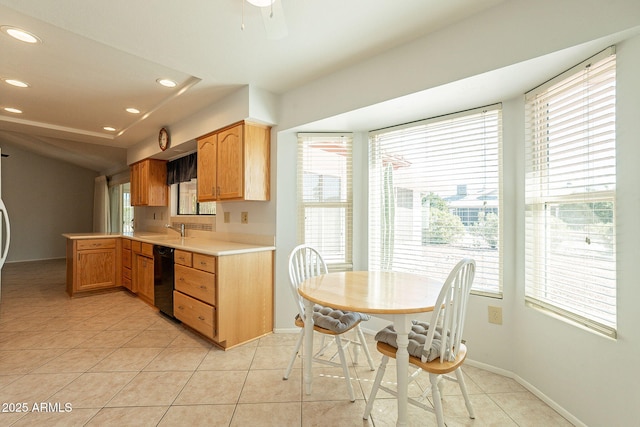 kitchen featuring dishwasher, sink, and light tile patterned floors