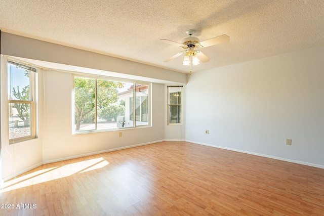 spare room featuring ceiling fan, a textured ceiling, and light hardwood / wood-style flooring