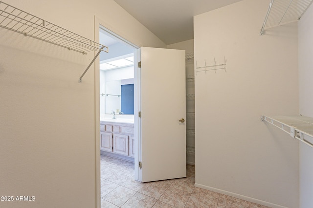 walk in closet with light tile patterned floors