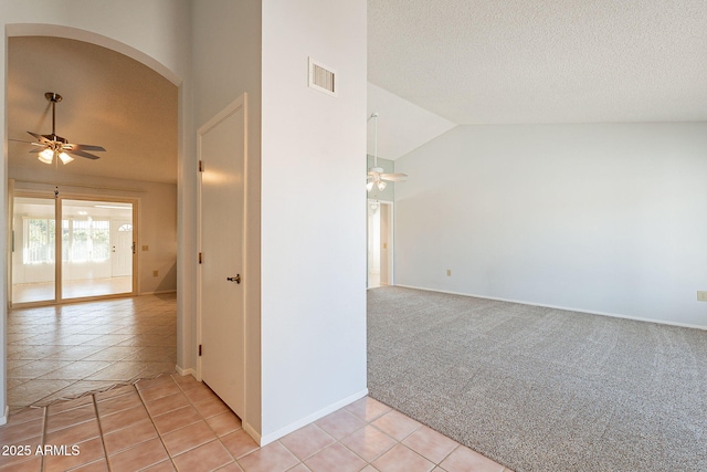 unfurnished room featuring ceiling fan, high vaulted ceiling, light carpet, and a textured ceiling