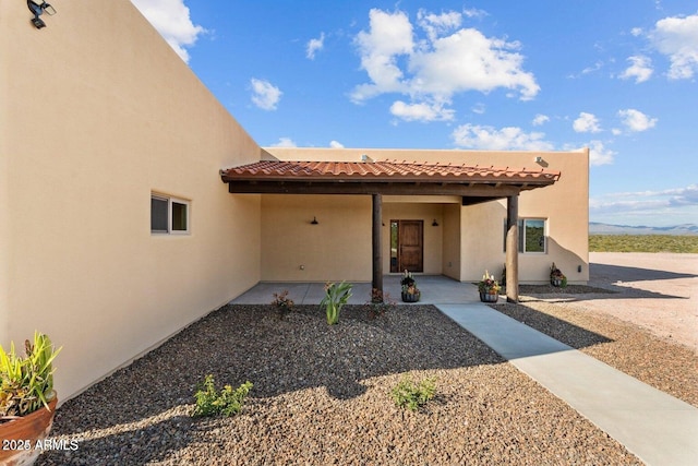 doorway to property featuring a patio