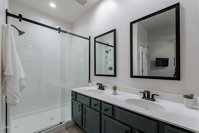 bathroom featuring vanity, tile patterned floors, and an enclosed shower