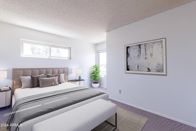 bedroom with carpet, a textured ceiling, and baseboards