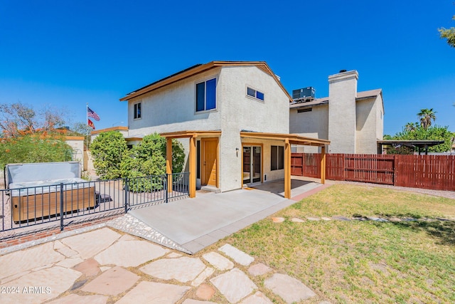 back of property featuring a patio, fence, a yard, central air condition unit, and stucco siding