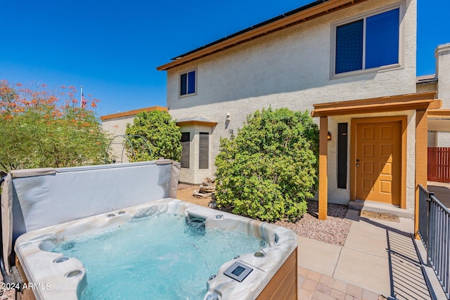 exterior space with a hot tub