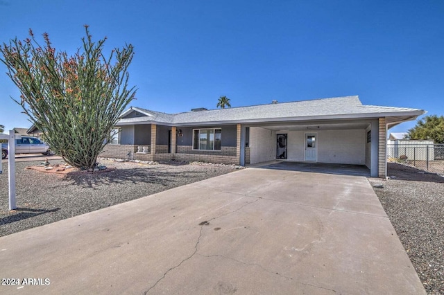 ranch-style home featuring a carport