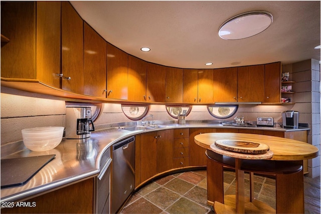 kitchen with stainless steel dishwasher, stainless steel counters, sink, and tasteful backsplash