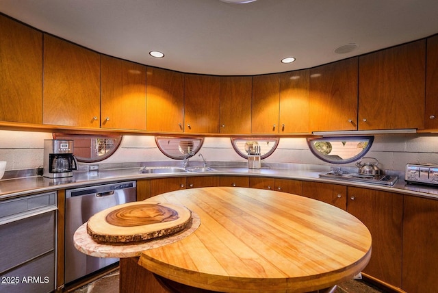 kitchen featuring stainless steel counters, sink, decorative backsplash, and appliances with stainless steel finishes