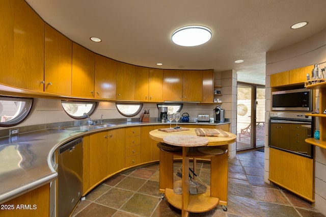 kitchen featuring stainless steel appliances, stainless steel counters, and sink