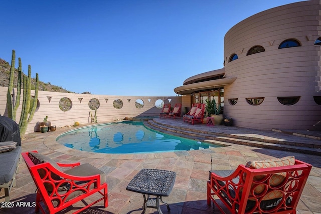 view of swimming pool with a patio area