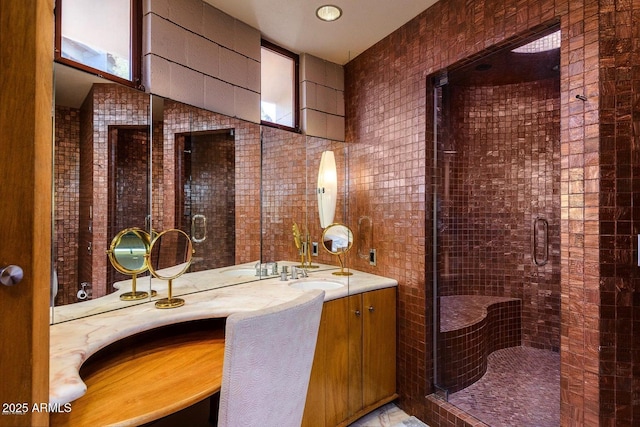 bathroom with vanity and a shower with door