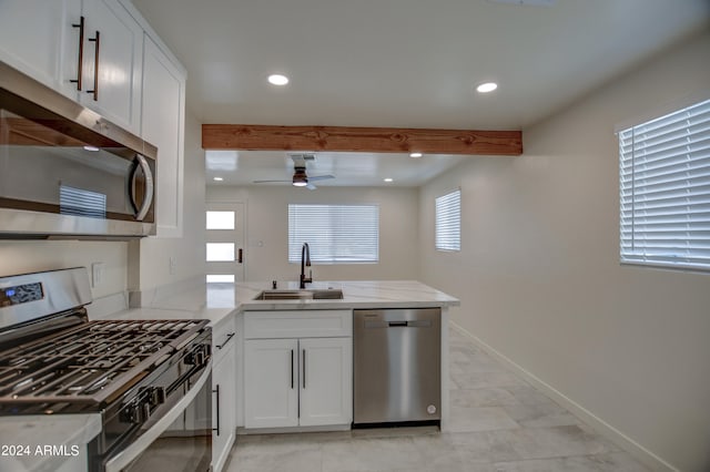 kitchen featuring kitchen peninsula, ceiling fan, stainless steel appliances, white cabinetry, and light tile floors