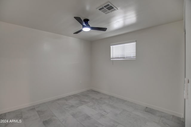 tiled spare room with ceiling fan