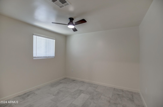 tiled empty room with ceiling fan