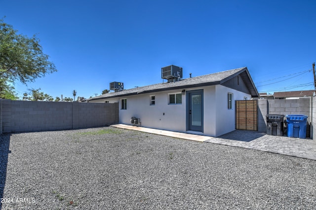 back of house featuring central AC and a patio area