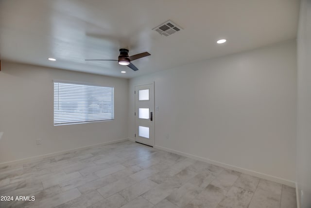 tiled empty room with ceiling fan