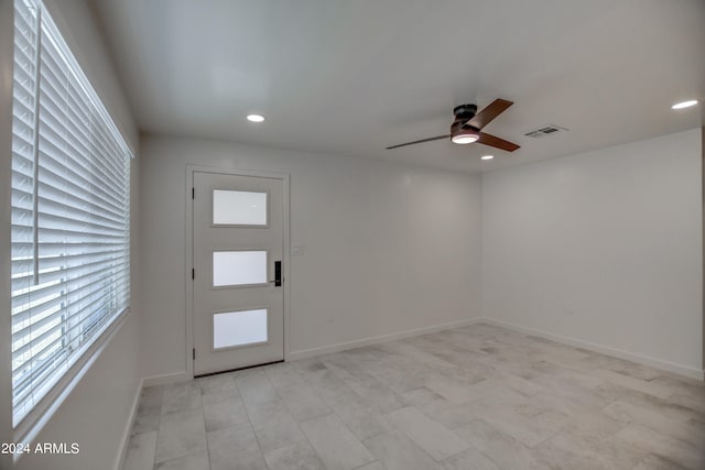 tiled entrance foyer featuring ceiling fan