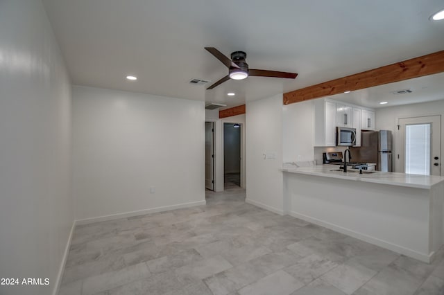 kitchen featuring light tile flooring, white cabinetry, stainless steel appliances, sink, and ceiling fan