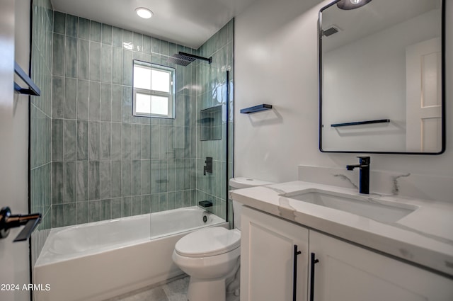 full bathroom featuring tiled shower / bath combo, large vanity, toilet, and tile flooring