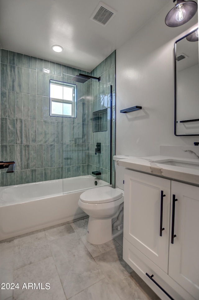 full bathroom featuring vanity, toilet, tiled shower / bath, and tile flooring