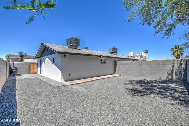 rear view of property with central air condition unit