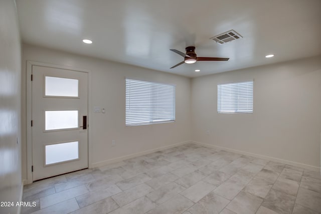 tiled foyer with ceiling fan