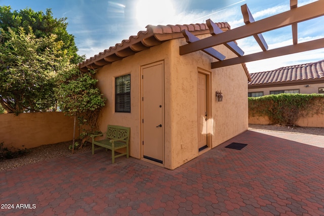 view of outdoor structure with a pergola