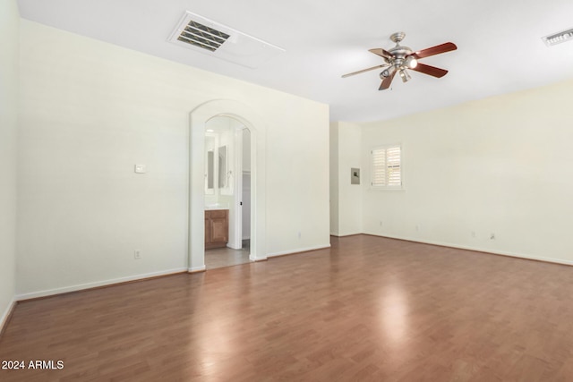 spare room with ceiling fan and dark wood-type flooring