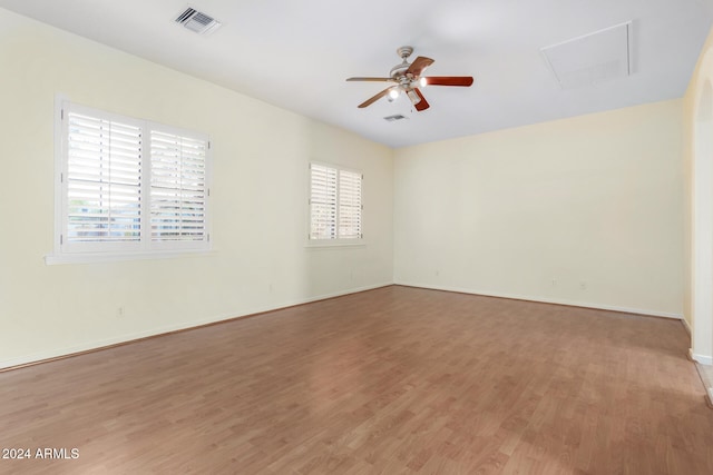 unfurnished room with ceiling fan and hardwood / wood-style flooring