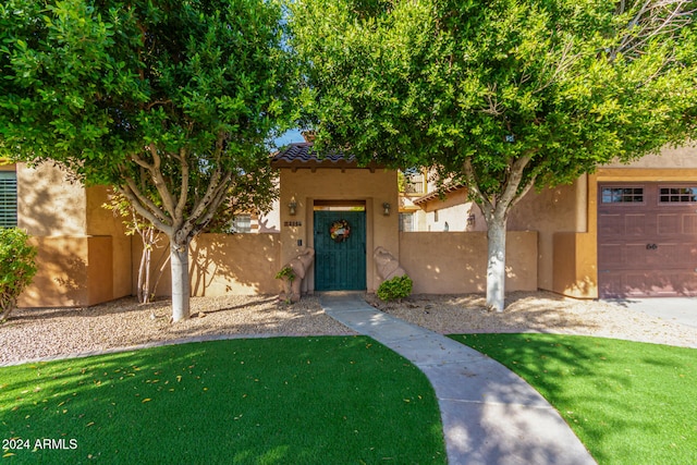 view of front facade with a front yard and a garage