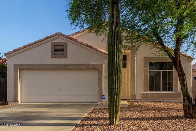 10735 W Bermuda Dr, Avondale, AZ 85392 - view of front of property with stucco siding, concrete driveway, a garage, and a tile roof
