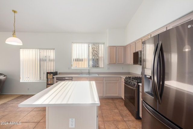 10735 W Bermuda Dr, Avondale, AZ 85392 - kitchen with stainless steel appliances, a sink, light countertops, a center island, and light tile patterned floors