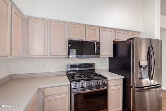10735 W Bermuda Dr, Avondale, AZ 85392 - kitchen with stainless steel appliances, light countertops, and light brown cabinetry