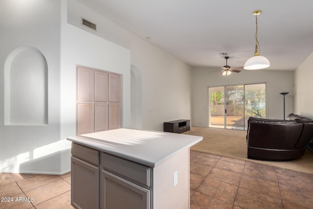 10735 W Bermuda Dr, Avondale, AZ 85392 - kitchen with arched walkways, open floor plan, a kitchen island, and hanging light fixtures