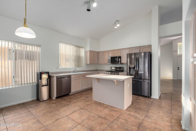 10735 W Bermuda Dr, Avondale, AZ 85392 - kitchen featuring stainless steel appliances, light countertops, a center island, healthy amount of natural light, and high vaulted ceiling