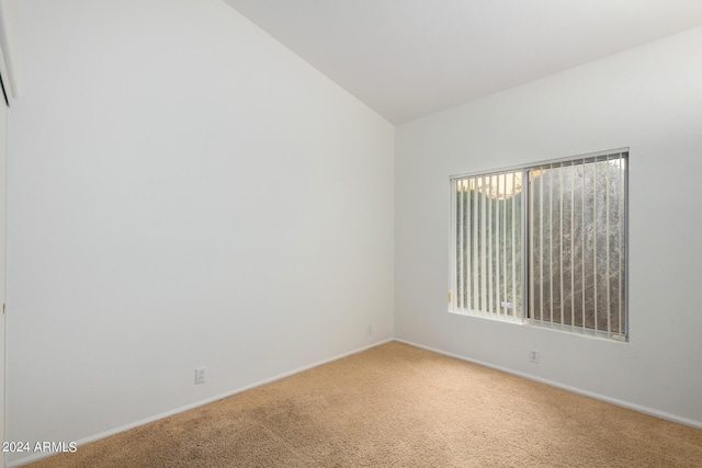 10735 W Bermuda Dr, Avondale, AZ 85392 - unfurnished room featuring light carpet, baseboards, and lofted ceiling