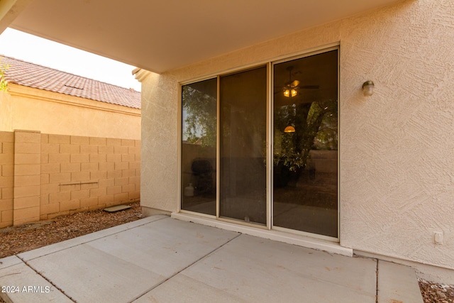 10735 W Bermuda Dr, Avondale, AZ 85392 - view of exterior entry with a patio, fence, and stucco siding