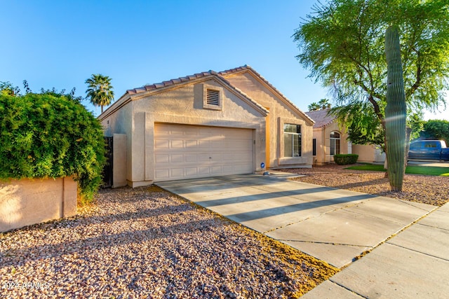 10735 W Bermuda Dr, Avondale, AZ 85392 - view of front of house with stucco siding, an attached garage, concrete driveway, and a tiled roof