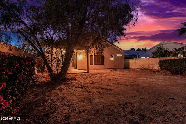 10735 W Bermuda Dr, Avondale, AZ 85392 - back of house at dusk featuring fence