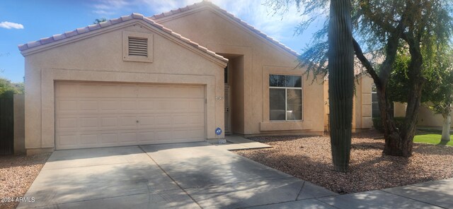 10735 W Bermuda Dr, Avondale, AZ 85392 - view of front of property with concrete driveway, an attached garage, stucco siding, and a tile roof