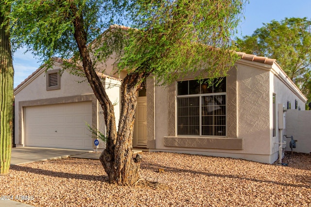 10735 W Bermuda Dr, Avondale, AZ 85392 - view of front of home featuring stucco siding, driveway, and a tile roof