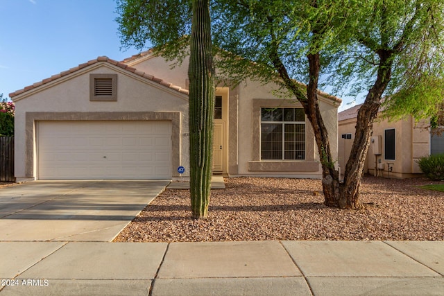 10735 W Bermuda Dr, Avondale, AZ 85392 - view of front facade with stucco siding, concrete driveway, and an attached garage