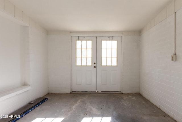 doorway featuring french doors and concrete floors