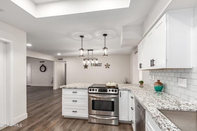 kitchen with kitchen peninsula, stainless steel appliances, and white cabinetry